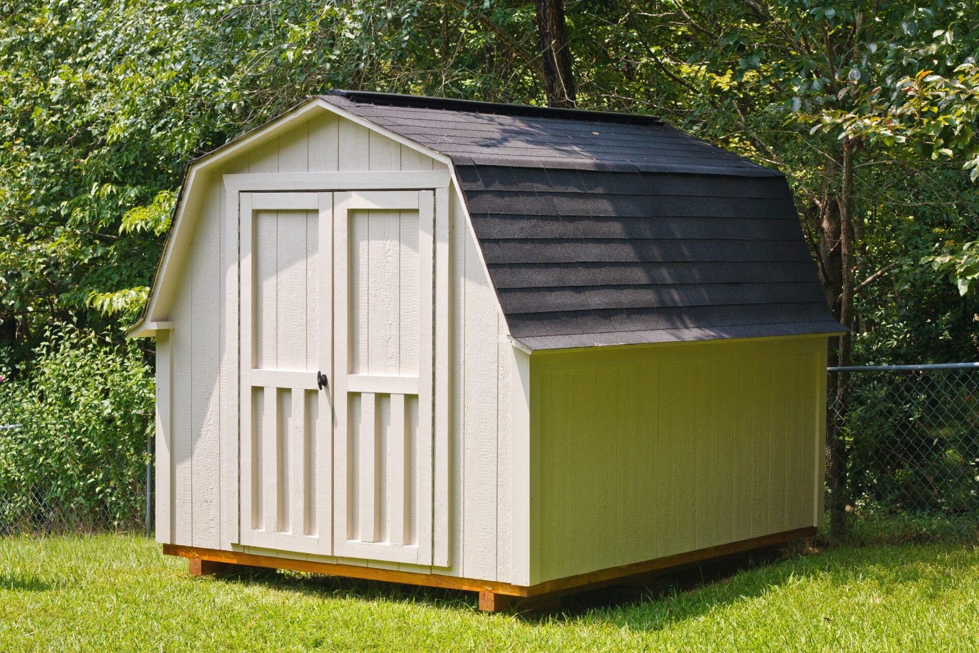 A wood utility shed in a back yard A wood utility shed in a back yard